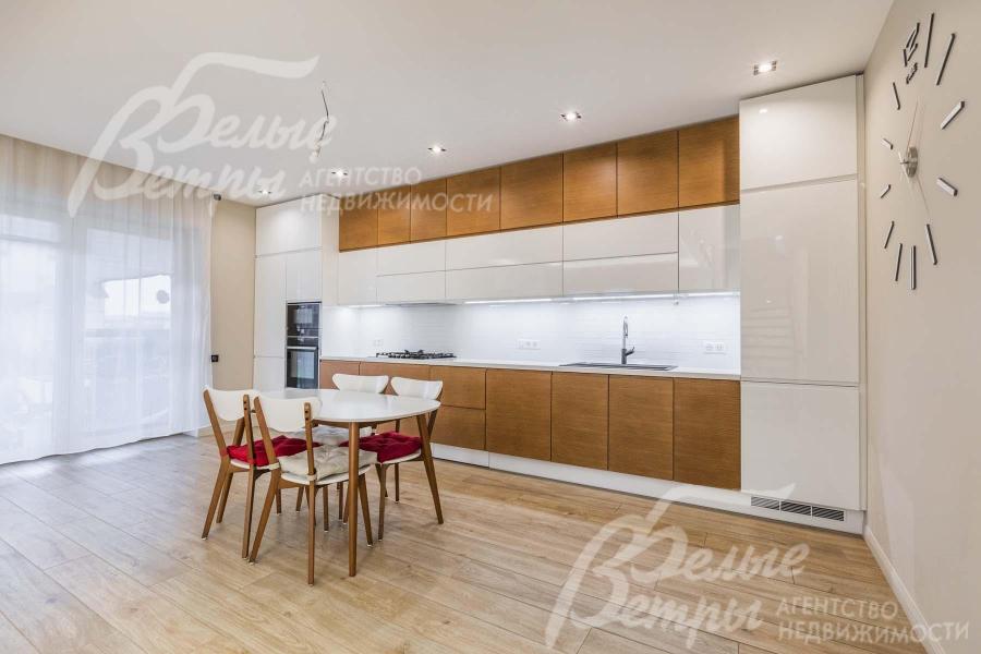 Установлена современная стильная кухня с белыми и деревянными фасадами