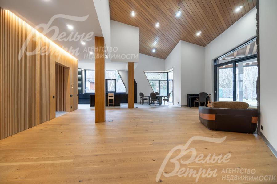 На потолке - отделка из натурального дуба и многоуровневое освещение, в том числе скрытое - с системой мастер-свет