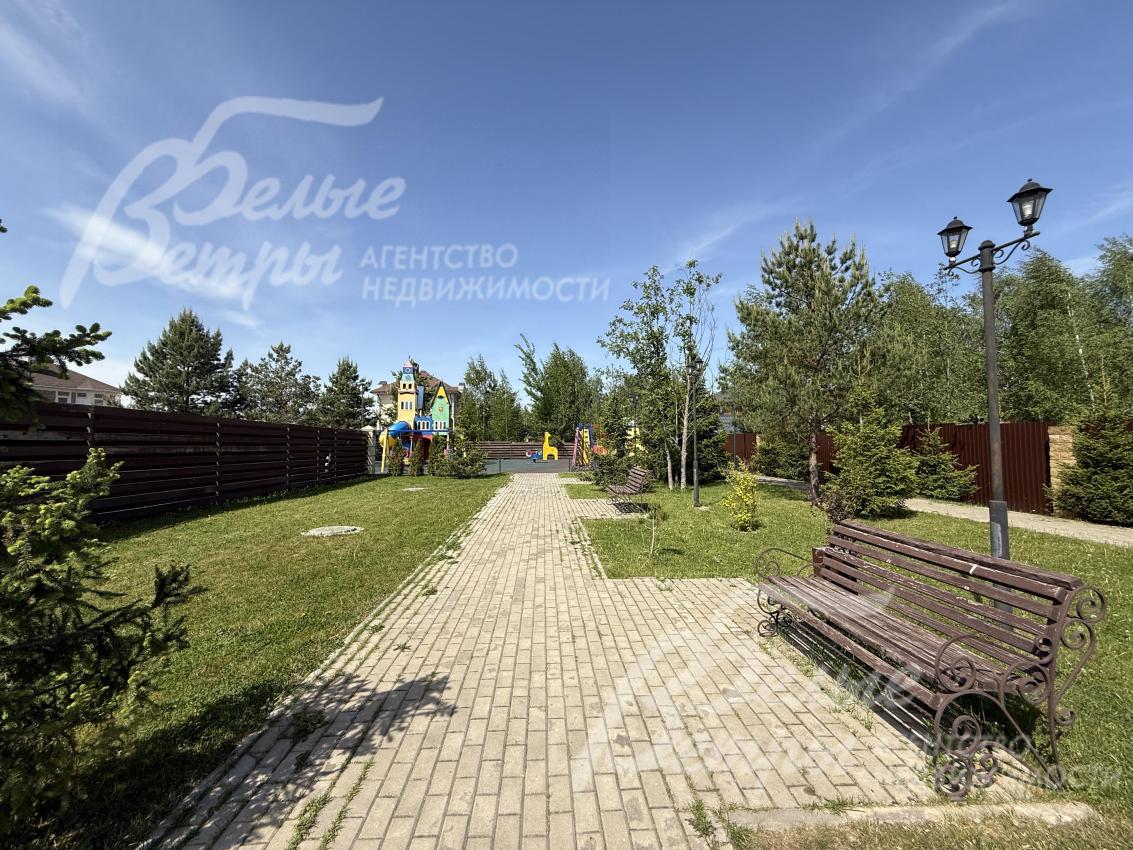 Прогулочная зона уложена плиткой, установлены скамейки и уличные фонари