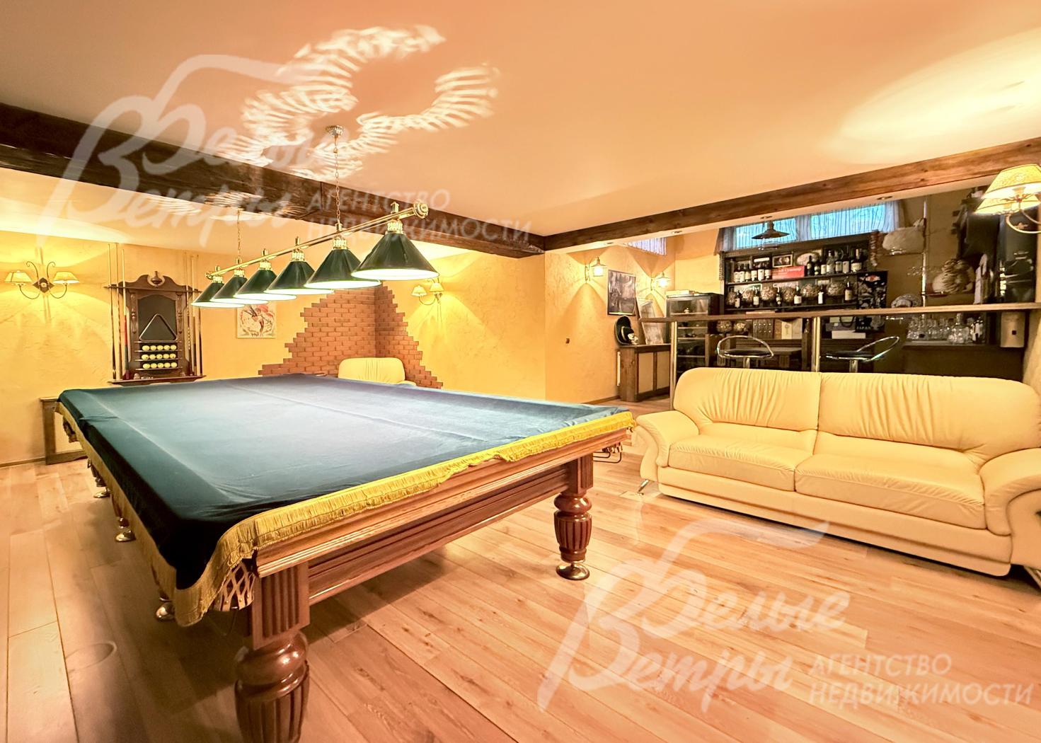 В доме - функциональный цокольный этаж с бильярдной, где также расположен бар и диван