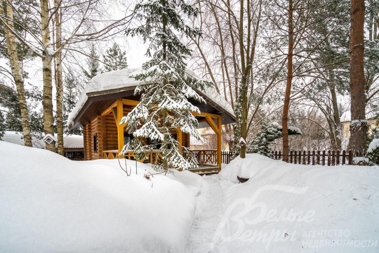 На участке построена одноэтажная баня из бревна с крытой террасой